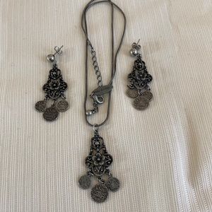 Silver flower necklace with matching earrings.